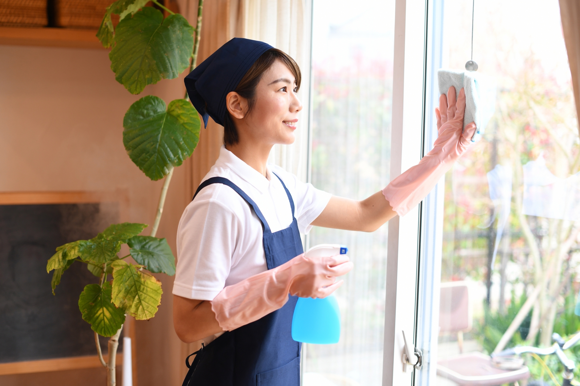 窓を掃除する女性